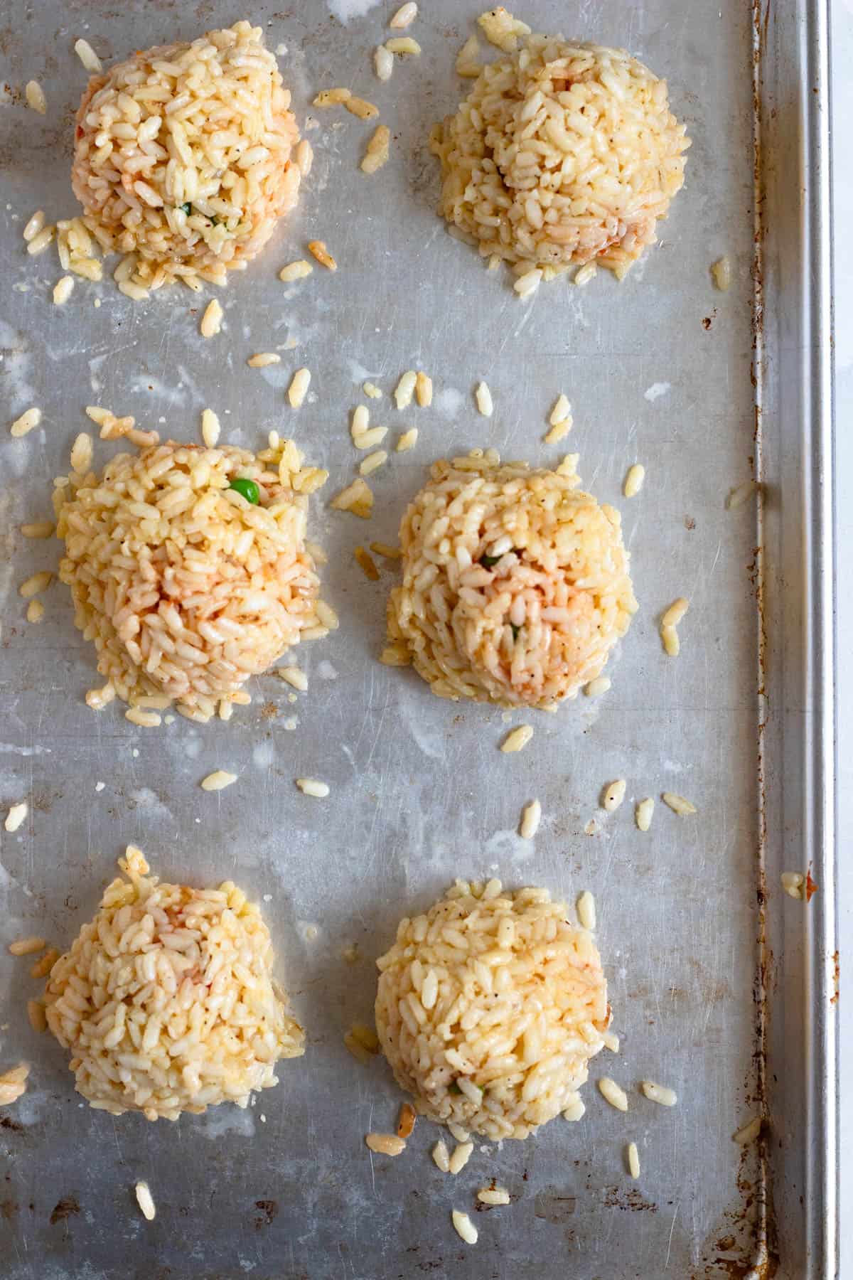 Rice balls arranged on a baking sheet.