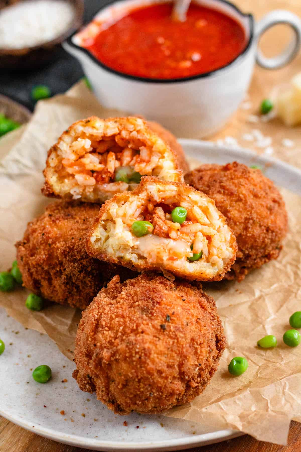 Crispy golden Arancini with green peas and mozzarella filing.
