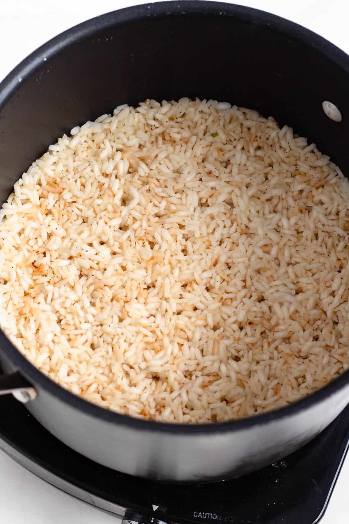A pot of cooked arborio rice.