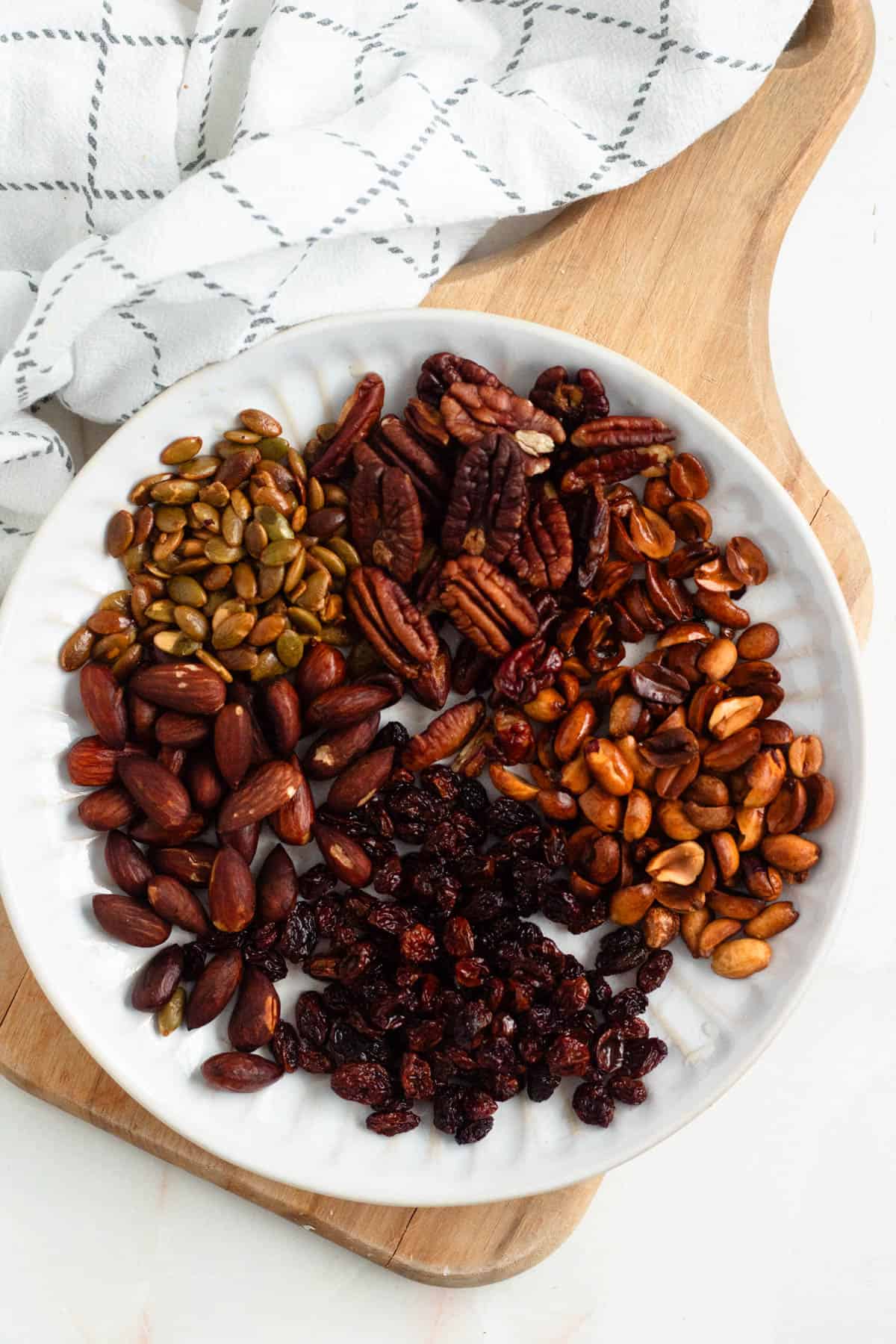 Plate of nuts, seeds, and raisins prepared as ingredients for mole sauce.