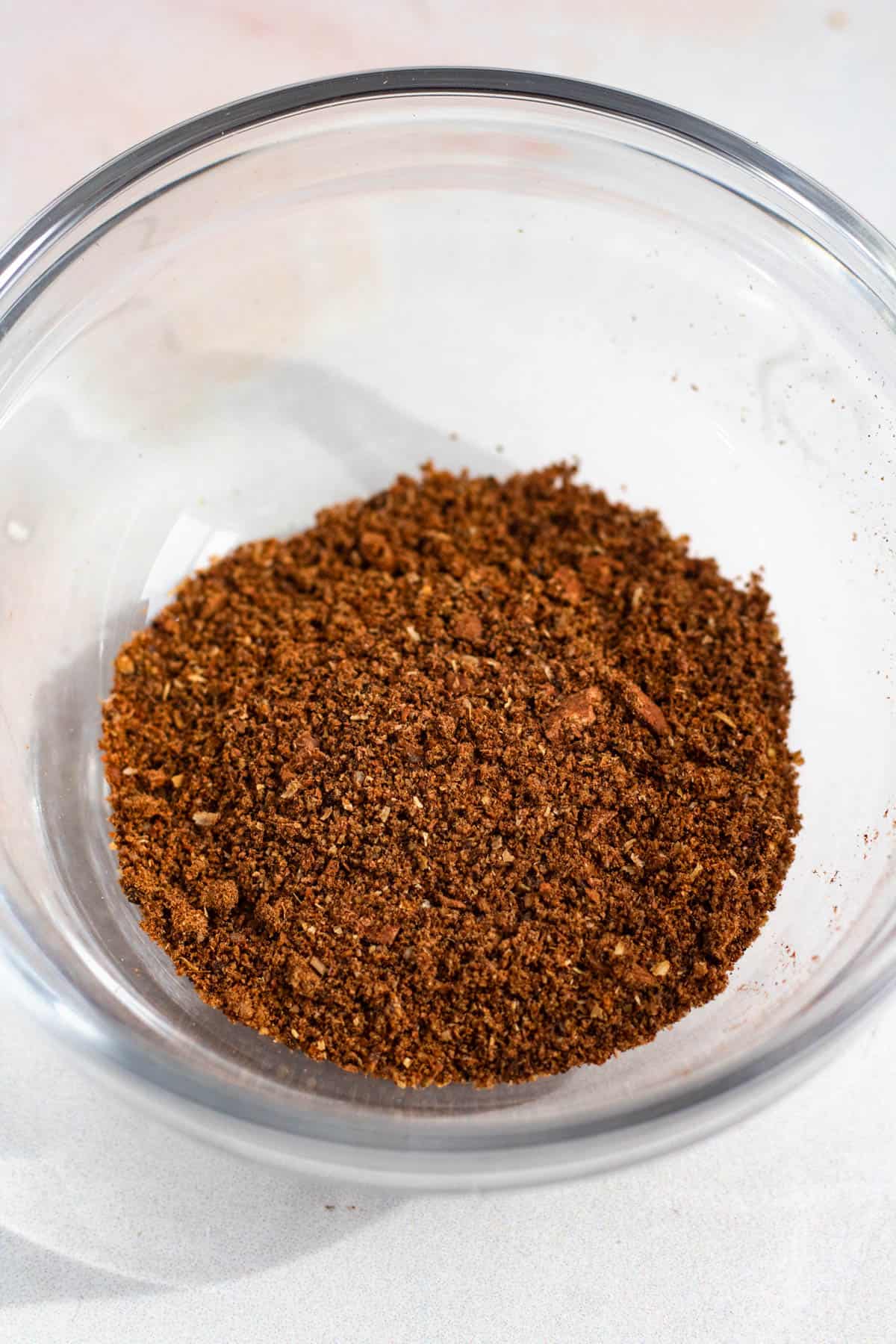 Ground spice mixture in a glass bowl.