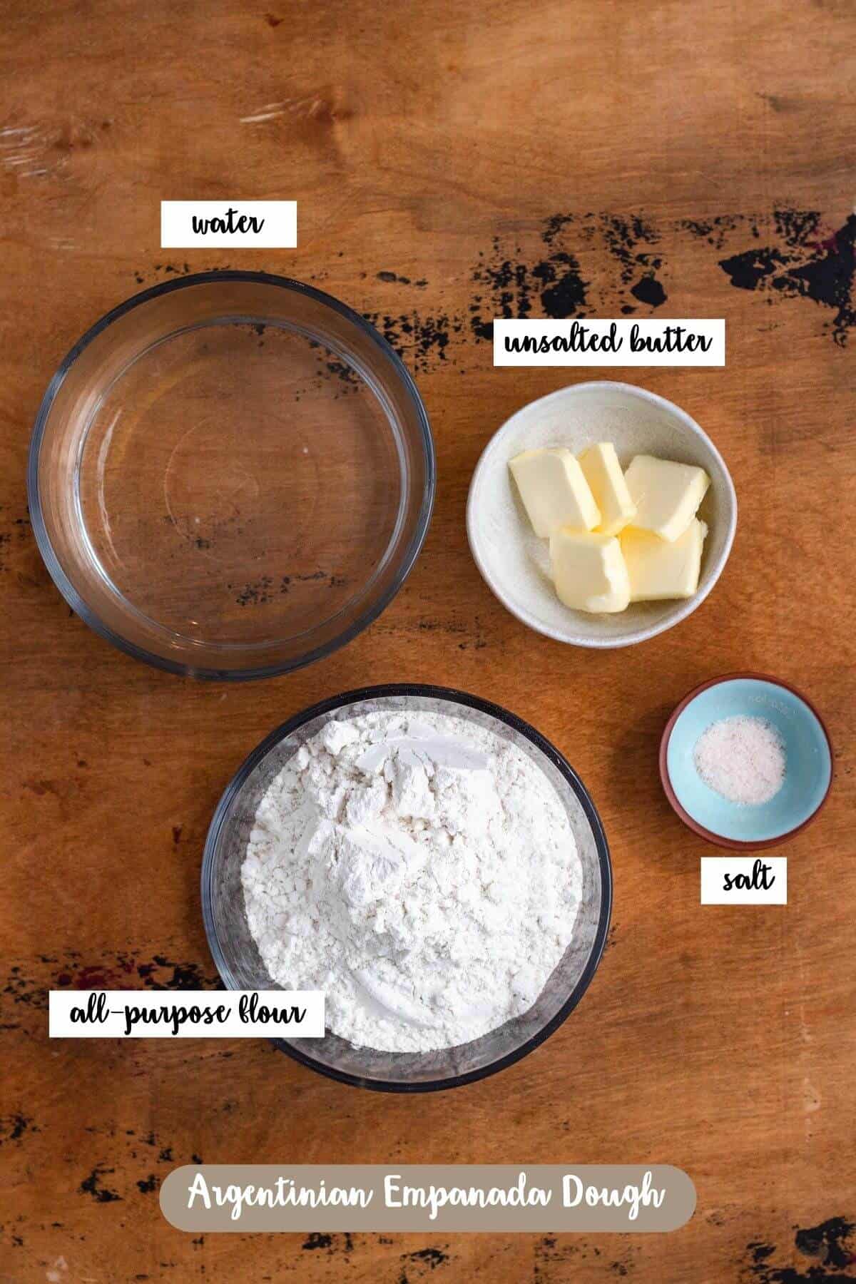 Ingredients for Argentinian empanada dough, including flour, butter, water, and salt.