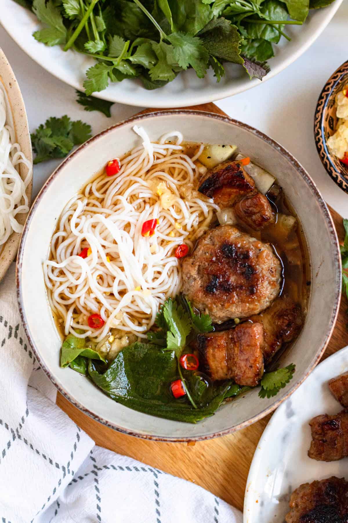 Delicious Bún Chả ready to serve with grilled pork, rice noodles, and more.