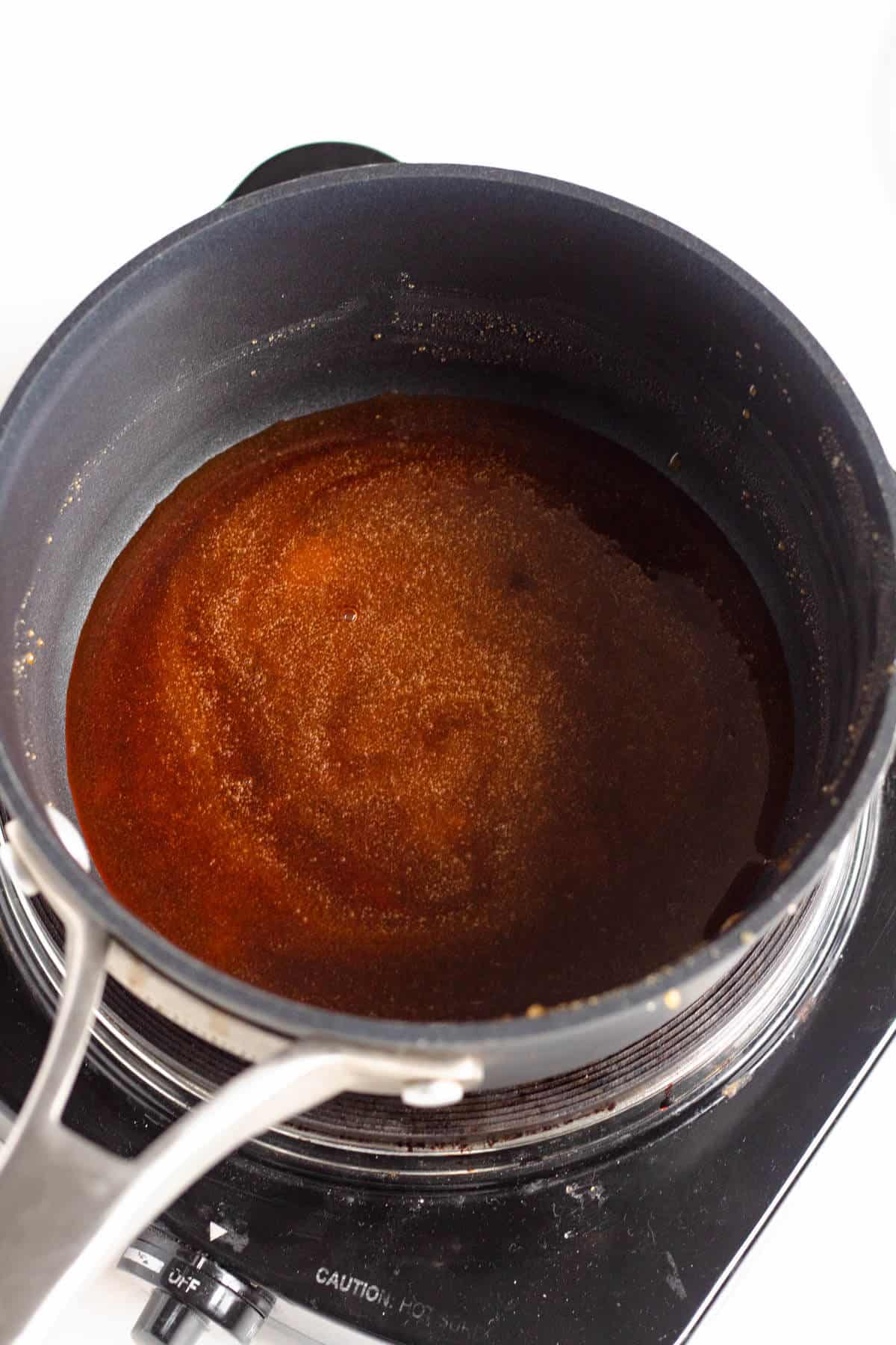 Golden caramel sauce for Bún Chả made with melted sugar and hot water.