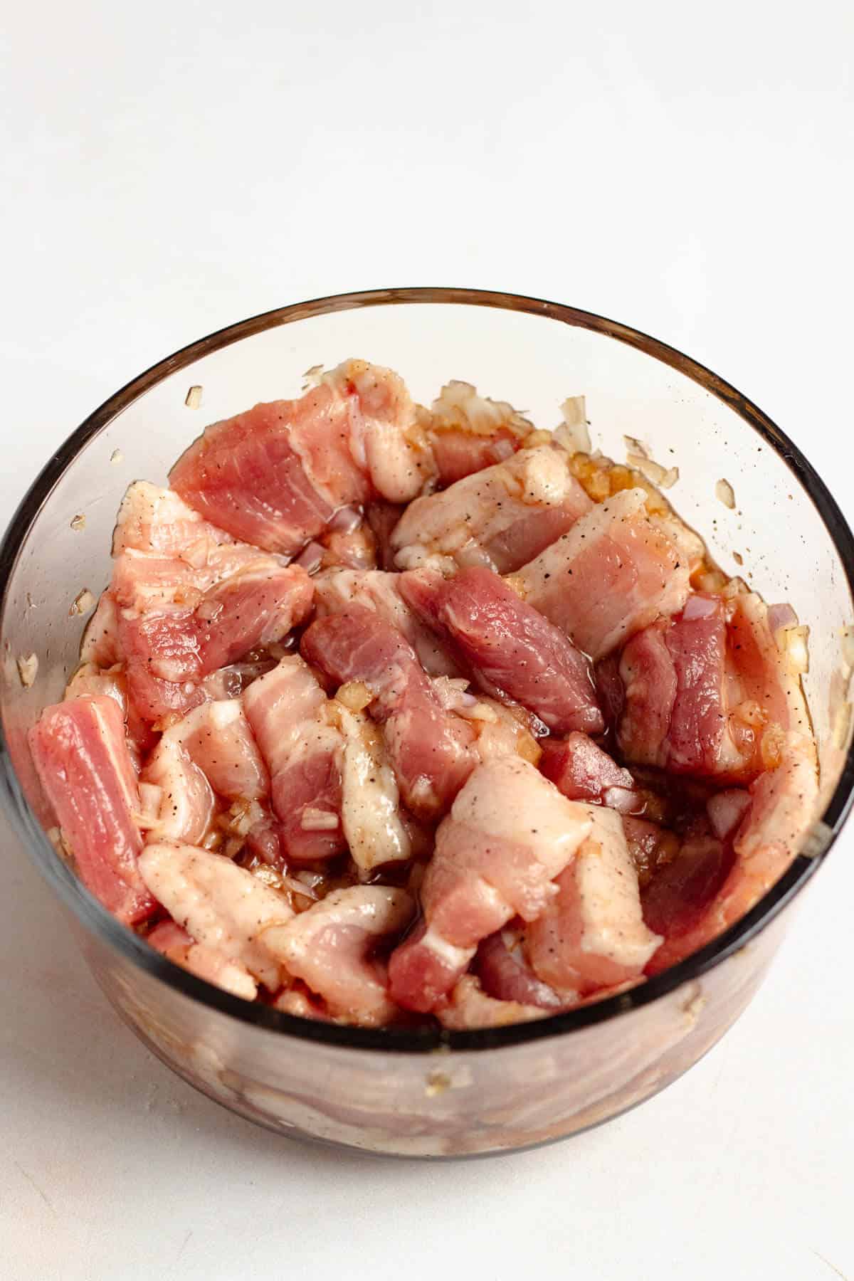 Pork belly marinating with fish sauce, caramel sauce, shallots, garlic, sugar, and pepper.