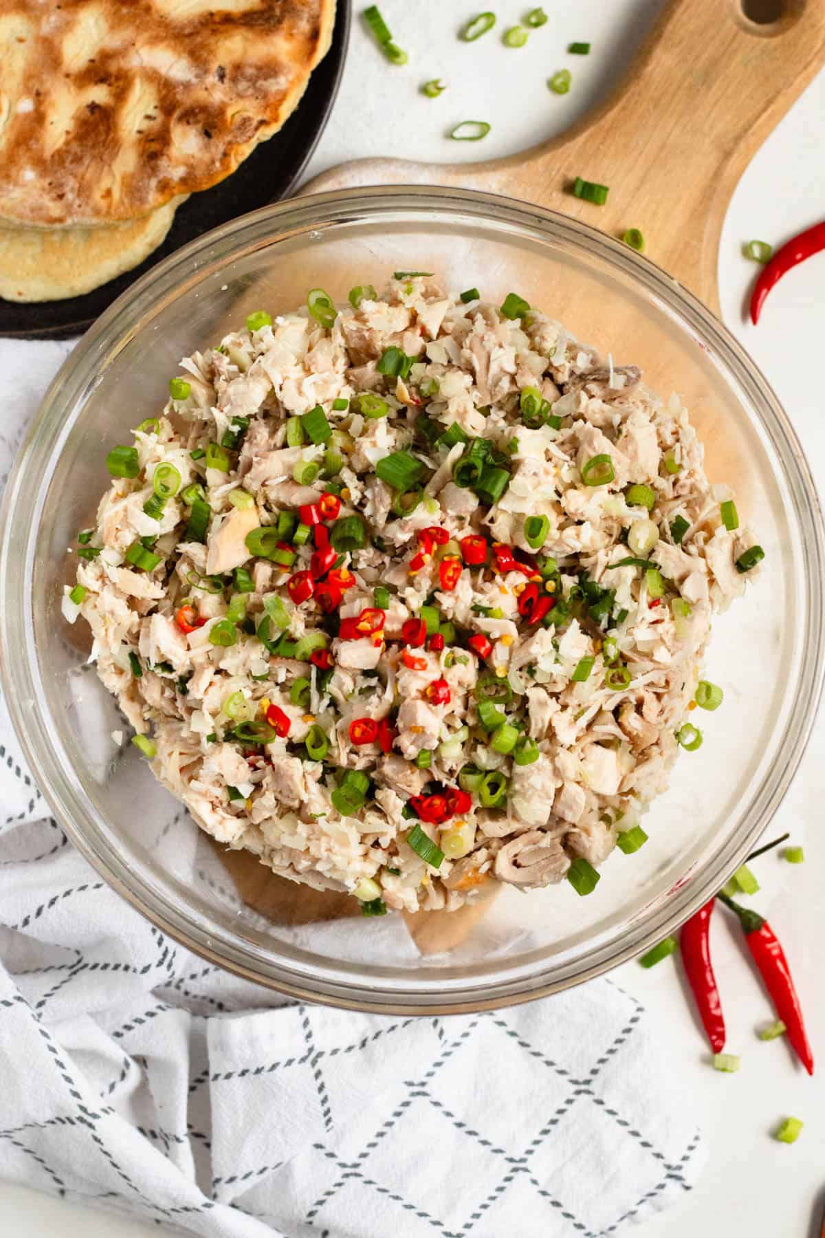 Delicious Chamorro Chicken Kelaguen with fresh coconut, green onions, and red chilies.