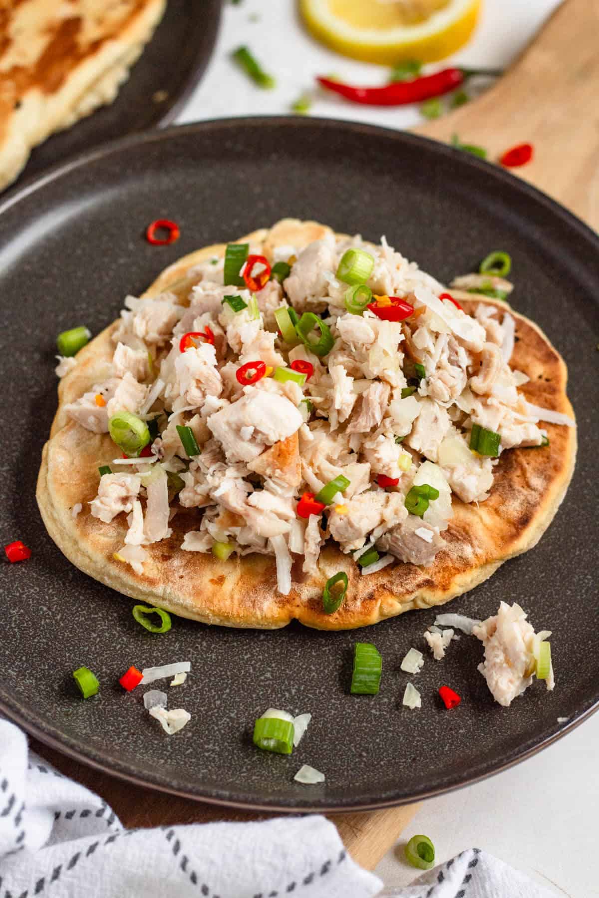 Chicken Kelaguen served on warm titiyas with lemon, peppers, and green onions.