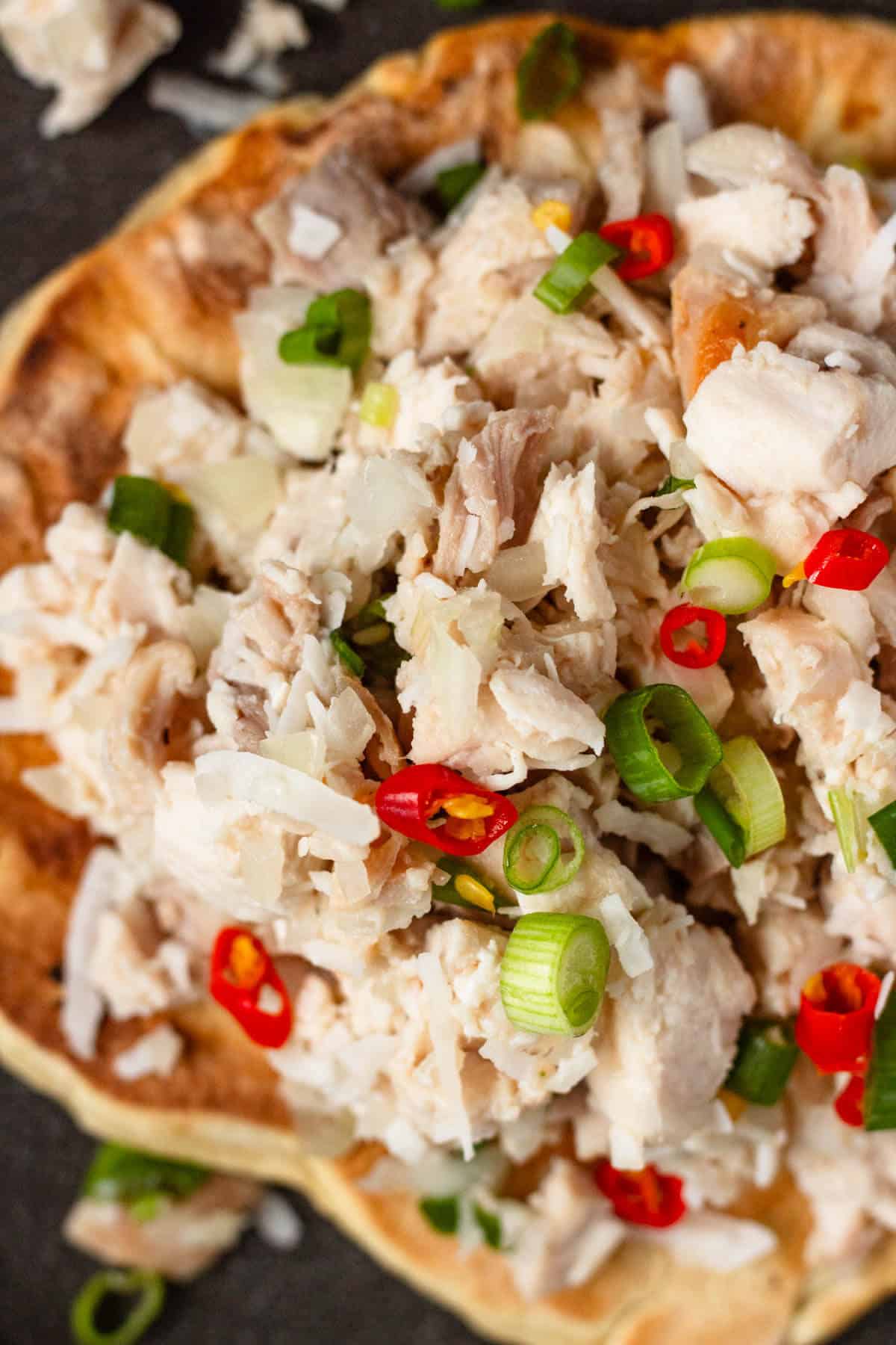 Chicken Kelaguen served on titiyas with green onions and red chilies.