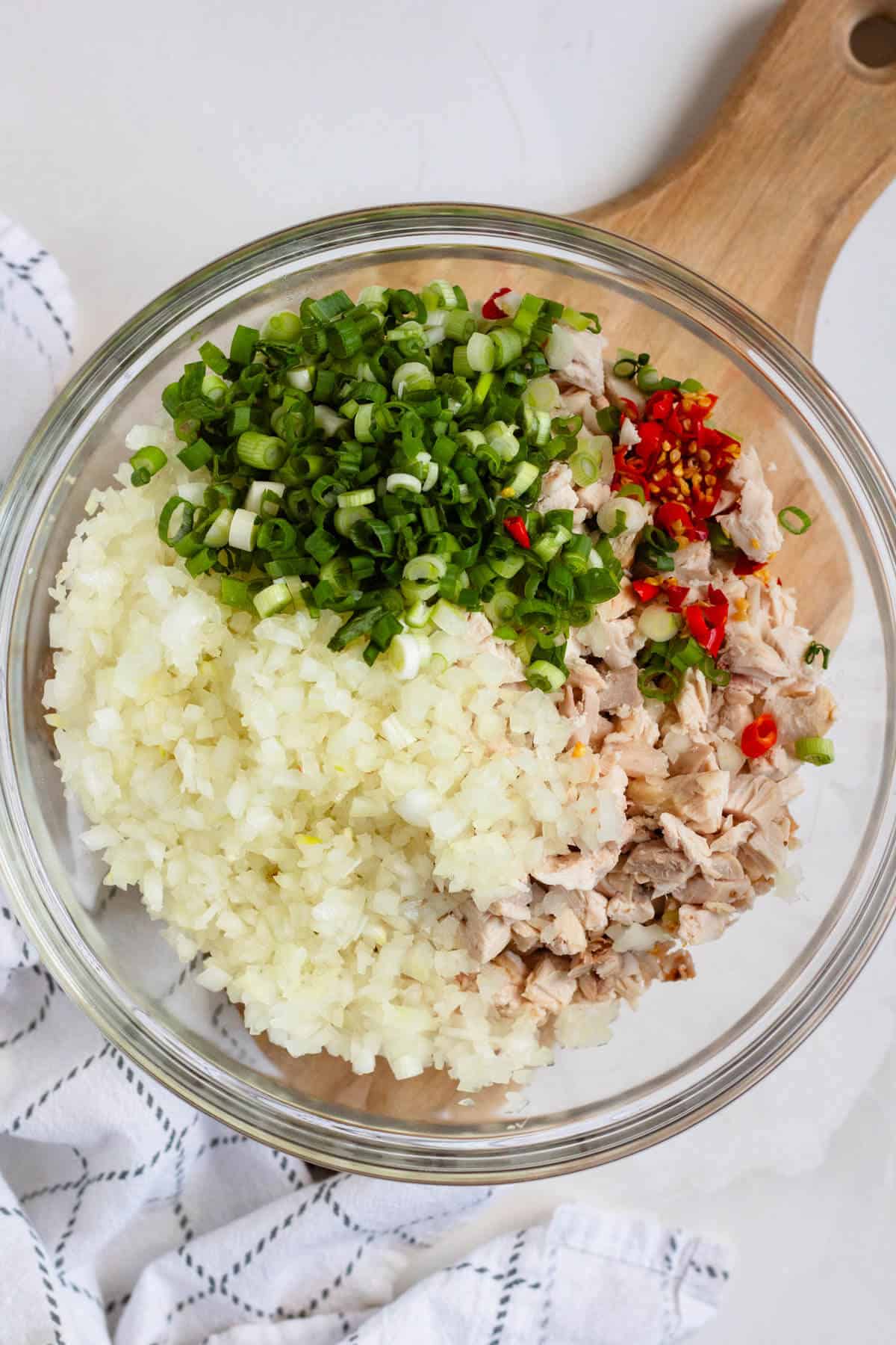 Chopped chicken, onions, green onions, and peppers ready to mix for Chicken Kelaguen.