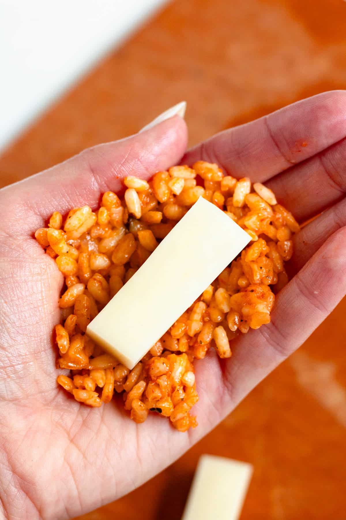 Mozzarella placed inside chilled supplì rice.