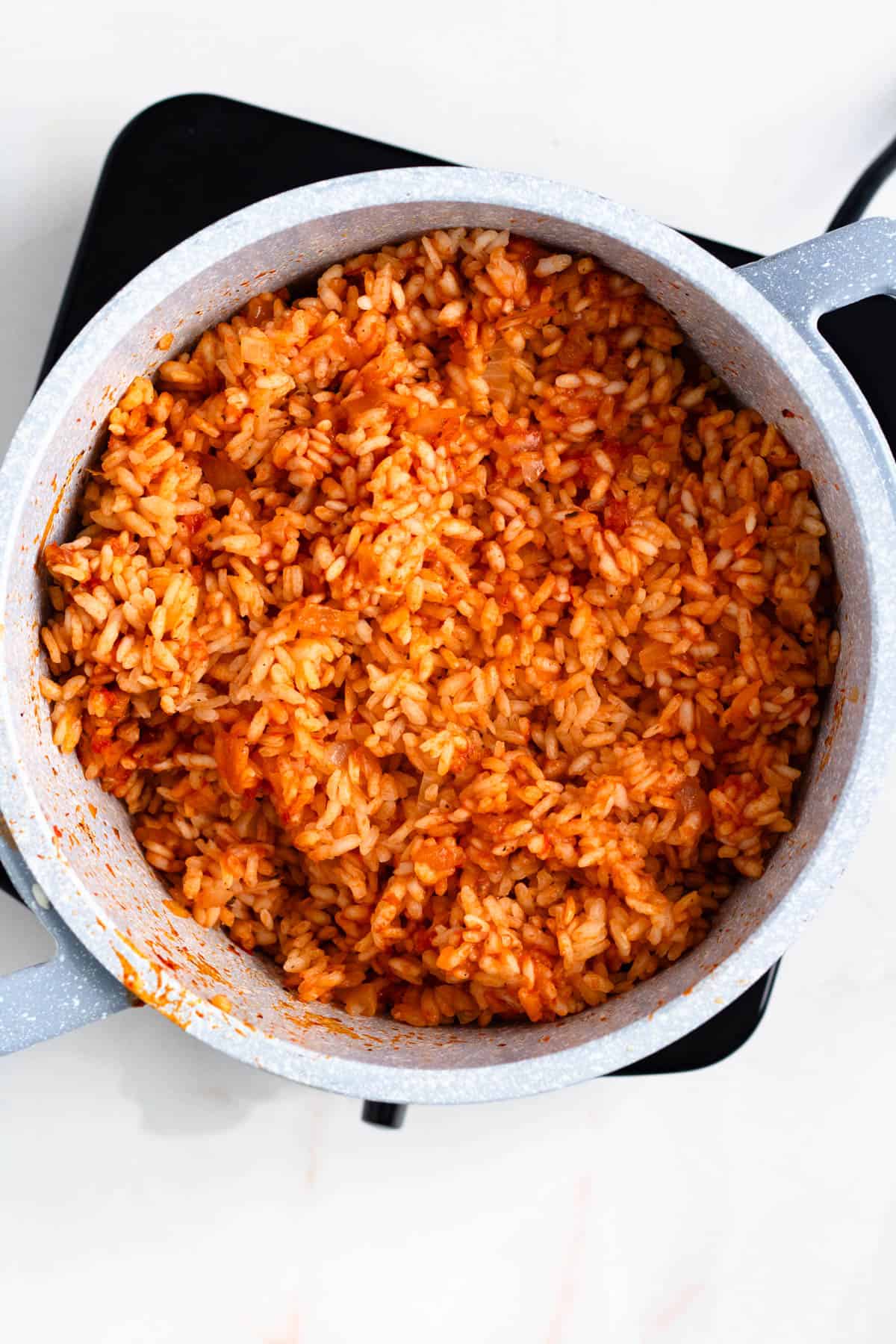 Arborio rice cooking in a pot with chicken stock and ragù for Supplì al Telefono.