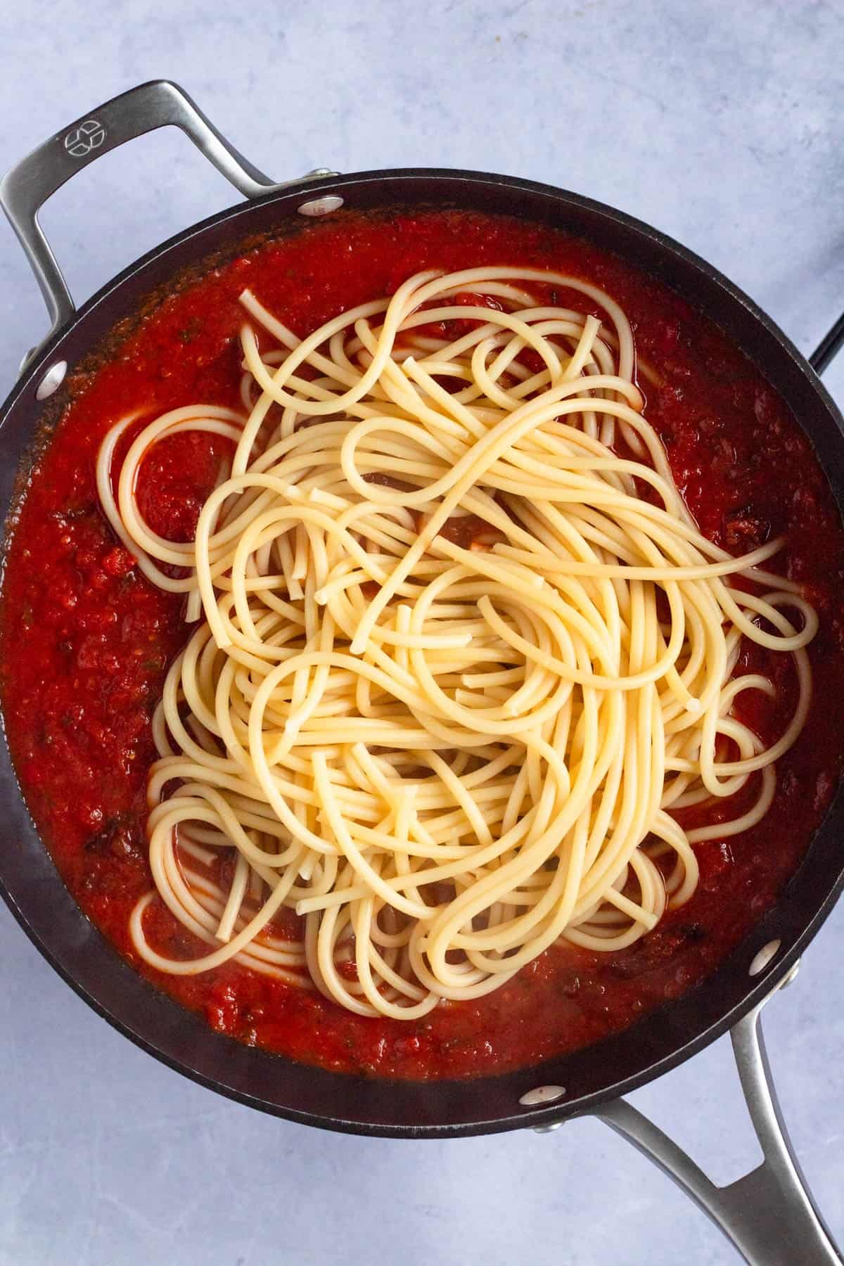 Bucatini tossed with rich tomato sauce and crispy guanciale for Amatriciana.