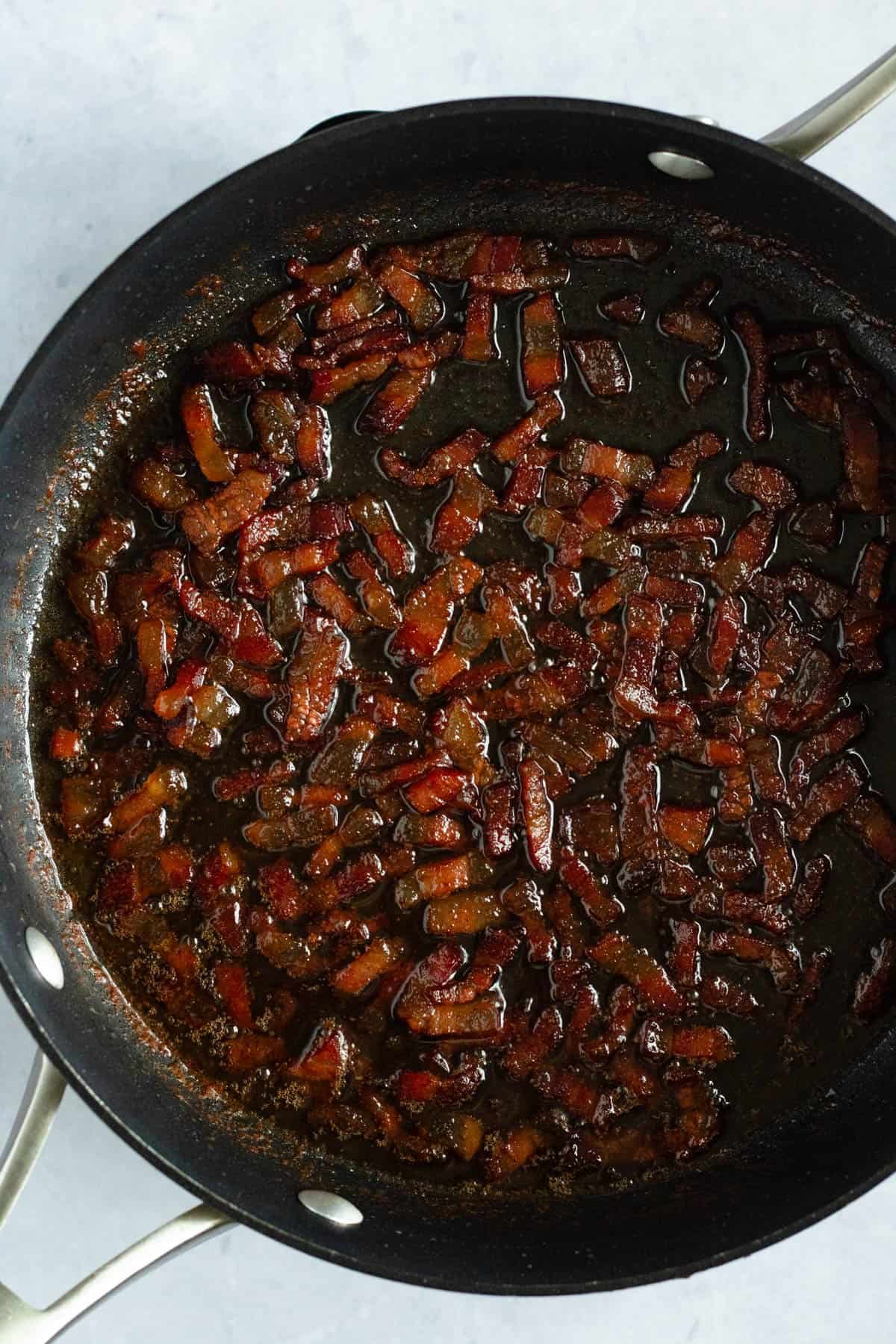 Guanciale simmering in white wine and rendered fat for Amatriciana sauce.