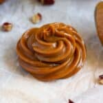 Thick homemade dulce de leche piped into a glossy caramel swirl.