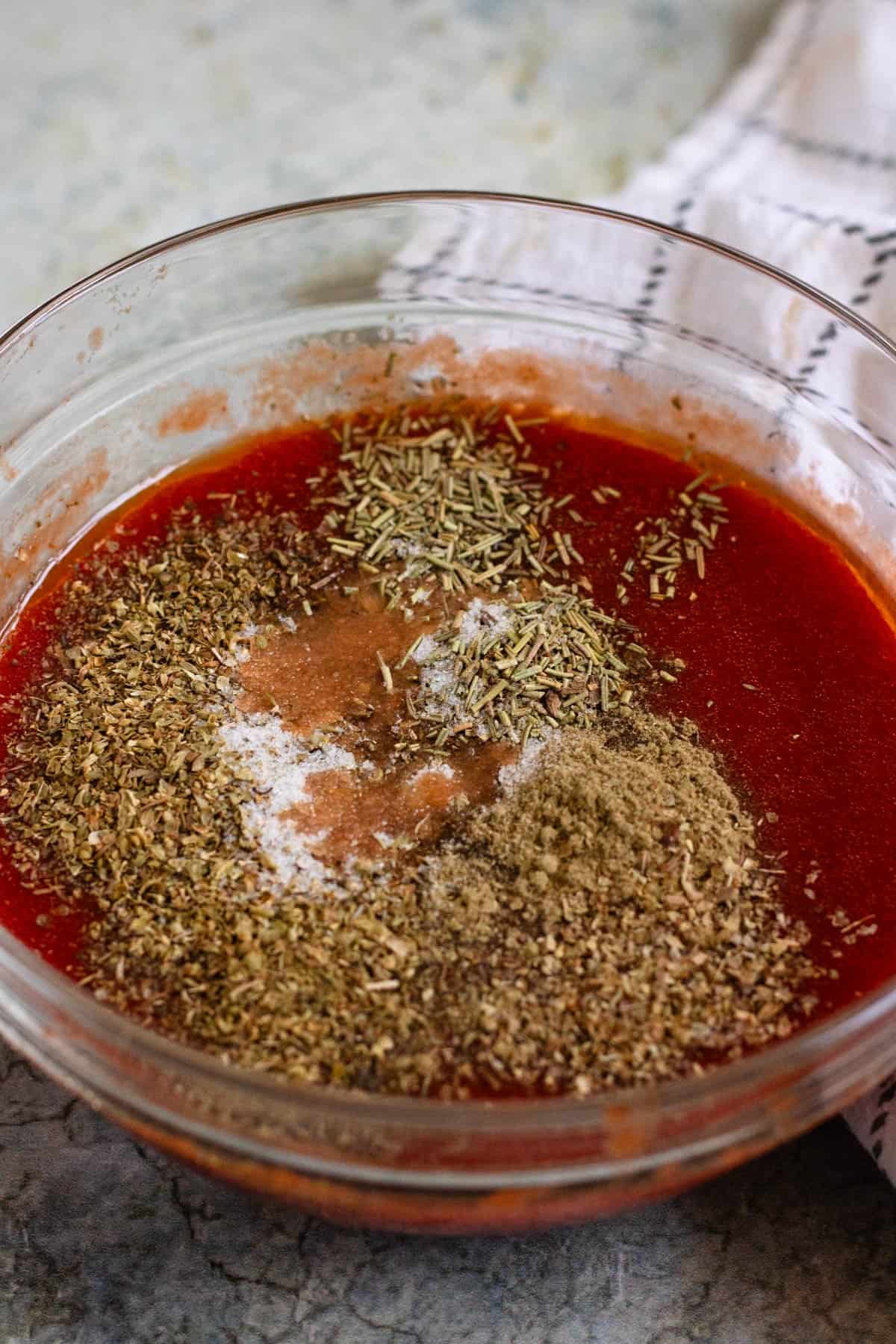 Homemade pizza sauce with dried herbs added to the tomato paste mixture.