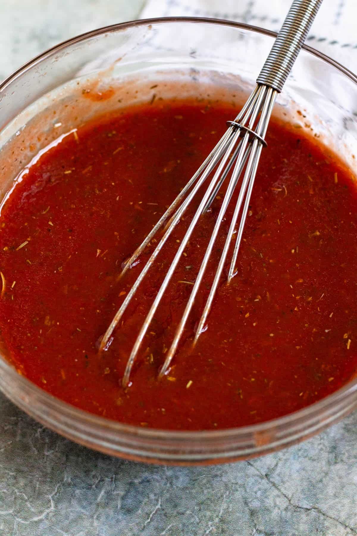 Homemade pizza sauce whisked until smooth and ready to use.