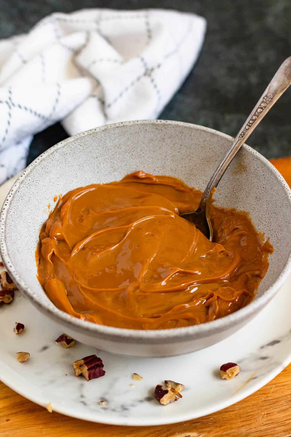 Smooth homemade dulce de leche whisked in a bowl until creamy.
