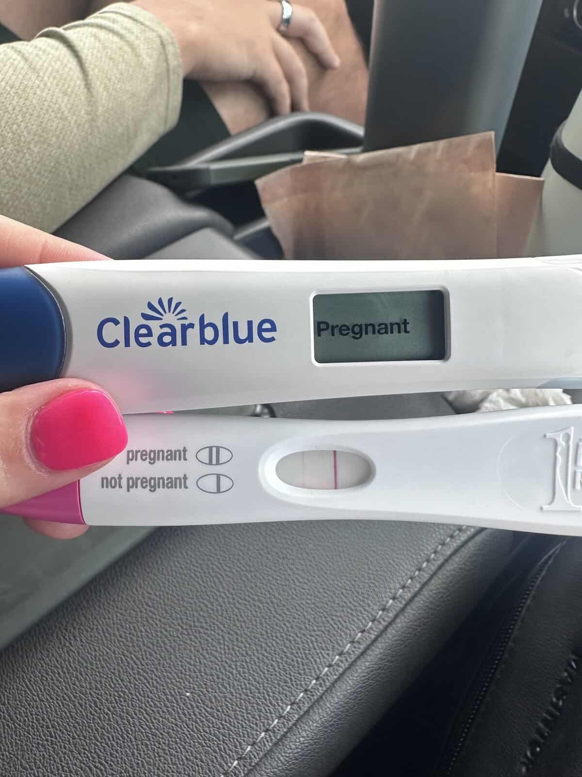 Two positive pregnancy tests, one of which says the word pregnant. 