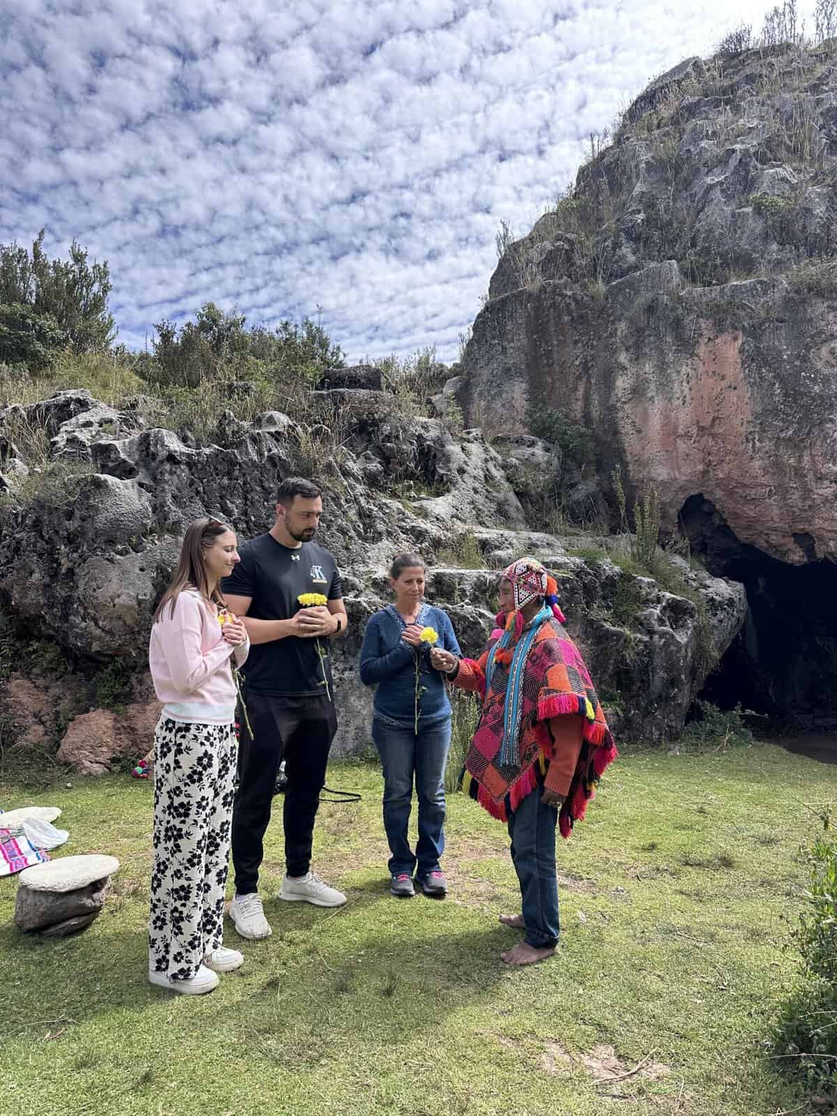 A group of three people talking to an Incan Shaman.