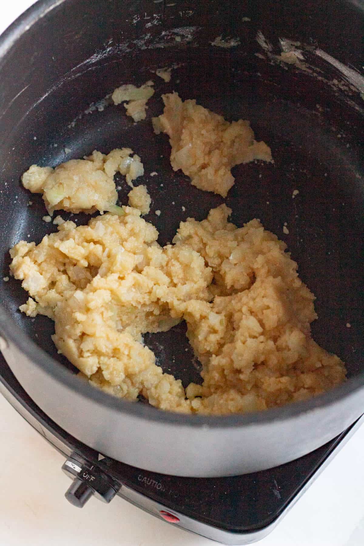 Butter and flour cooking together to make a roux for bitterballen filling.