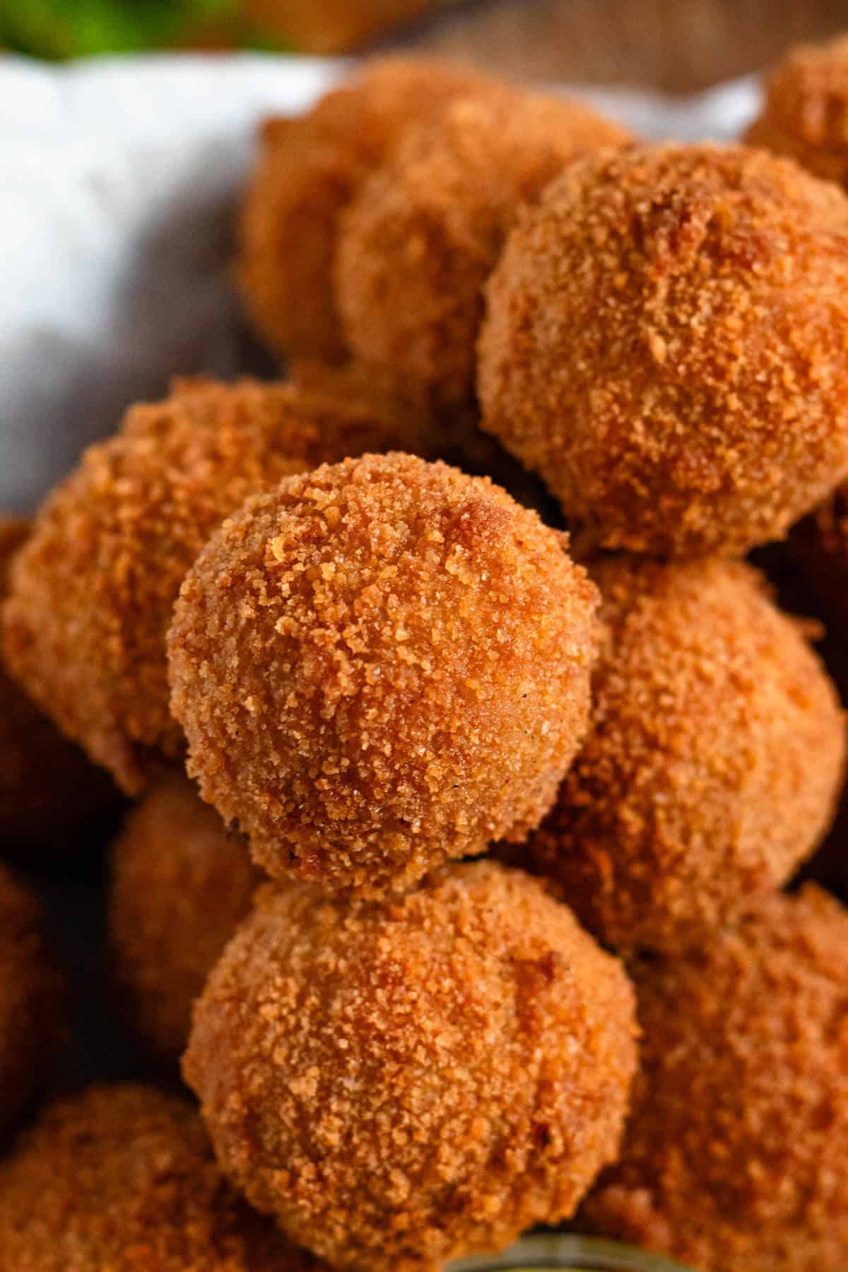 Golden fried bitterballen stacked and ready to serve with mustard.