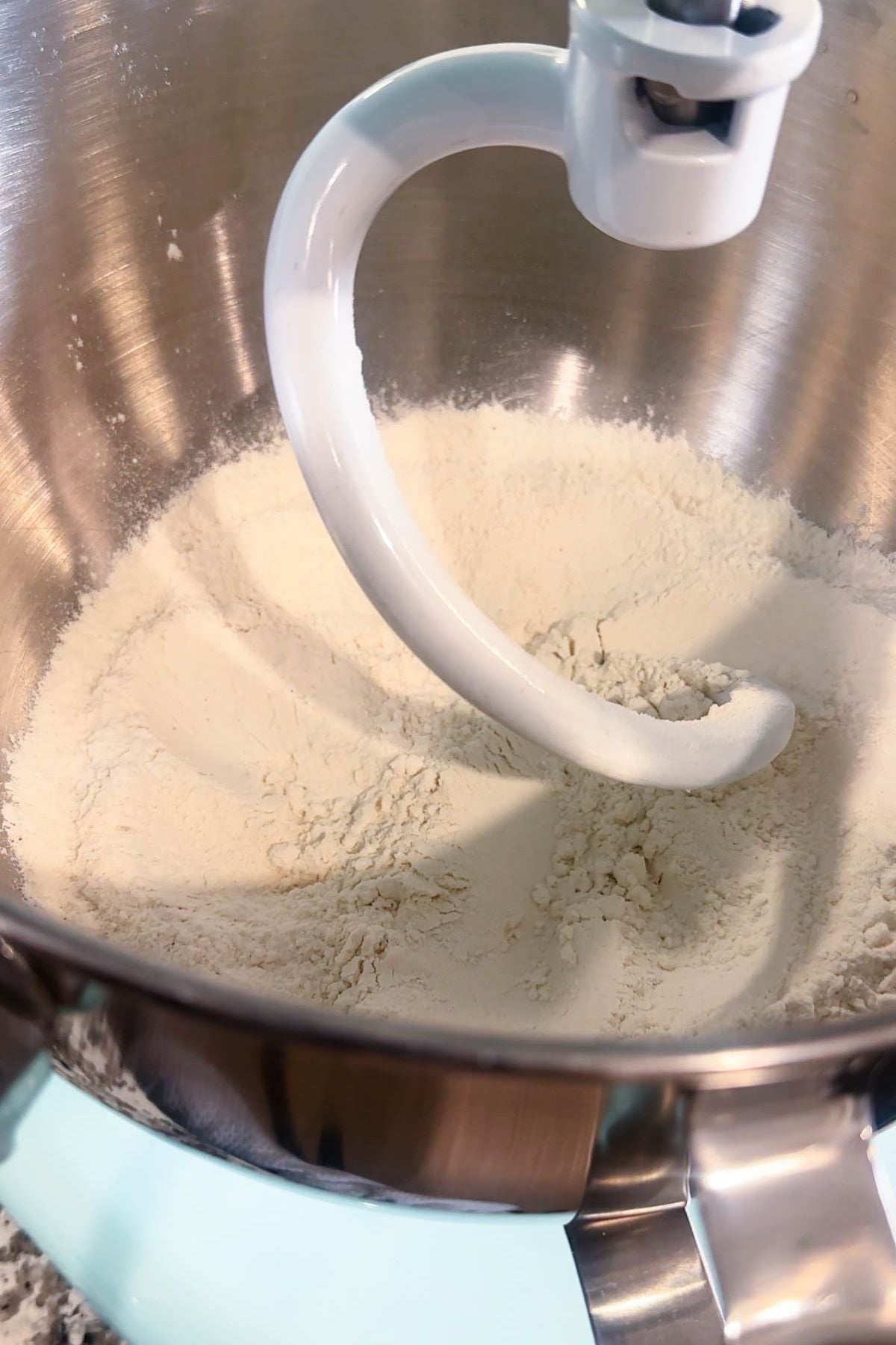 Flour, salt, and nutmeg in a stand mixer bowl for homemade spaetzle batter.